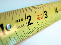 A yellow tape measure representing a linear foot
