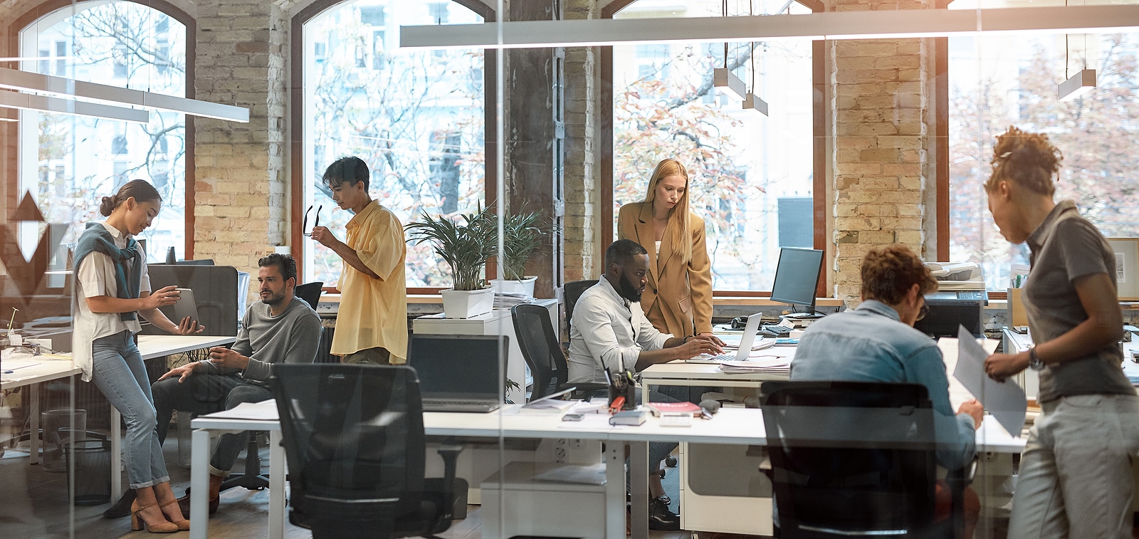 Document-scanning services can streamline workflows at your organization. A group of young employees in a trendy open-concept workspace collaborate.