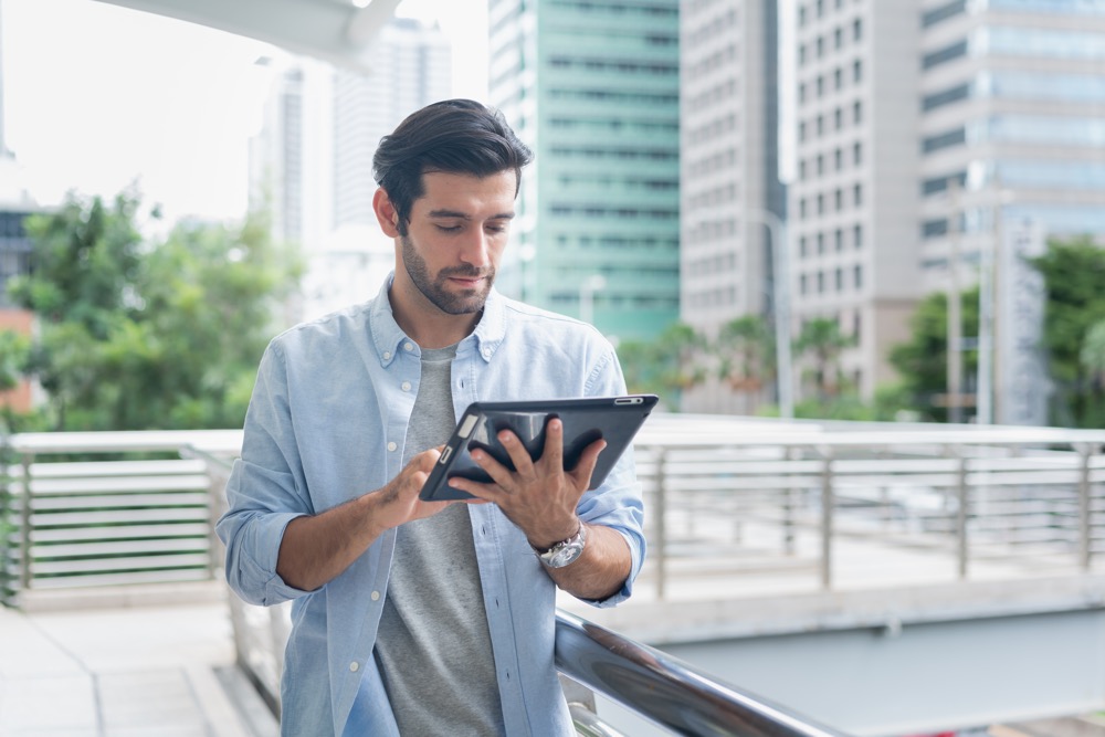 A manager working remotely from his tablet checks for mail and packages through the company's digital mailroom.