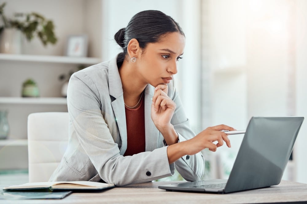 A female executive reviews the end-to-end process of accounts payable on her laptop.